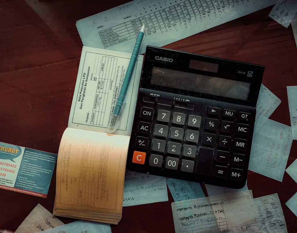 Calculator and receipts representing the breakdown of Malaysia work visa levy